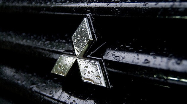 Mitsubishi logo on the wet car